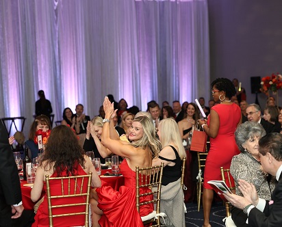 Crowd of seated guests clapping